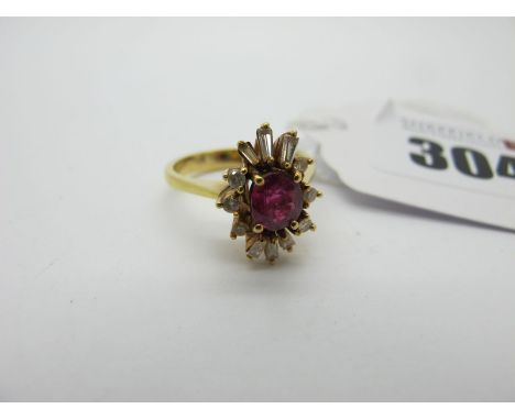 A Ruby and Diamond Cluster Ring, of abstract design, oval four claw set to the centre, within shaped border of baguette and b