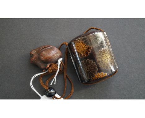 A Japanese lacquer two case inro and cover, Meiji period, decorated with sylized flowers, 5.5cm high, with carved wood netsuk