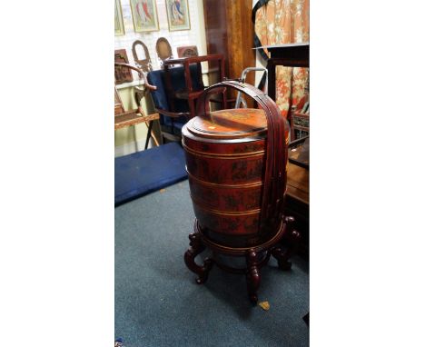 An Oriental lacquered and stained wood three tier circular wedding basket and cover, on stand, total height 92cm.