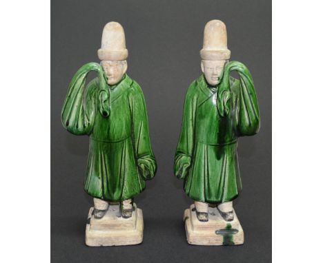 A pair of Chinese green glazed figures of standing attendants, Ming dynasty, 26cm high.
Provenance: The Verity Collection, so