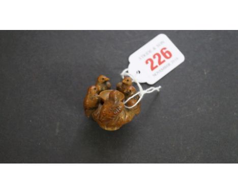An unusual vegetable ivory netsuke style group, of five birds surrounding a small bowl, 3.5cm high.