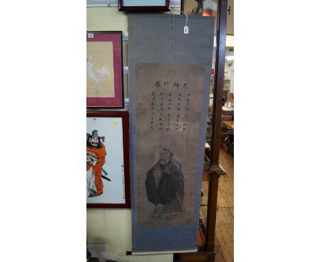 A Chinese watercolour scroll of a standing figure, signed and inscribed, 117 x 43cm.