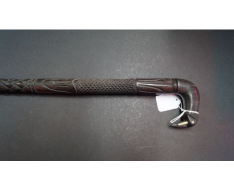 An Indian carved ebony walking stick, with elephant handle.