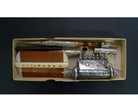 A mixed group of Oriental items, to include: a bone and sandalwood comb; a metal mounted pipe; a knife handle; and other meta