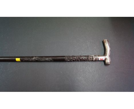 A Chinese silver mounted carved hardwood walking stick.