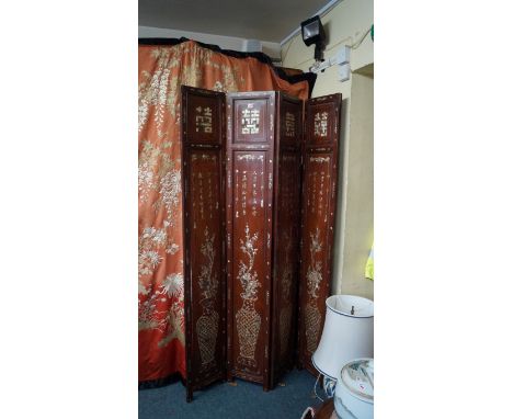 A Chinese hardwood and mother-of-pearl four fold screen, late 19th century, inlaid with vases issuing flowers and with column
