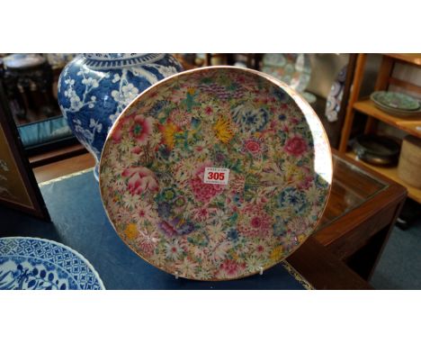 A Chinese famille rose mille fleurs circular bowl, Qianlong seal mark, 27cm diameter. Condition Report: Some wear to gilding.