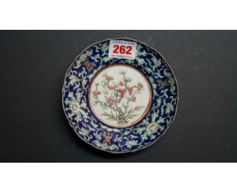 A Chinese saucer, Daoguang four character seal mark, painted with flowering prunus, 13cm diameter