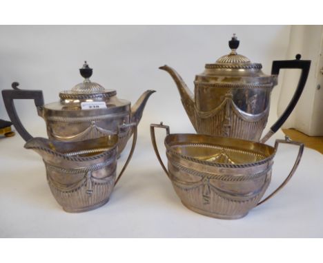 A late Victorian silver four piece tea set of oval, demi-reeded, draped and gadrooned form, the teapot with a swept spout, in