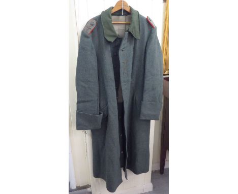 A German Army Greatcoat with epaulettes (Please Note: this lot is subject to the statement made in the Auctioneers Glossary o