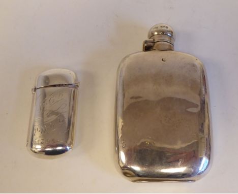 A silver cushion moulded hip flask with a rotating, hinged cap; and a lozenge shape vesta case with scrolled ornament&nbsp; b