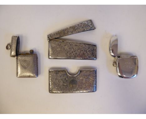 Four late Victorian/Edwardian silver collectables, viz. a scroll engraved visiting card holder; another with a hinged lid; a 