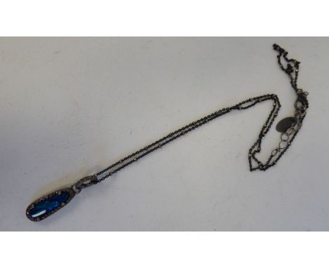 A black opal set pendant, on a fine neckchain