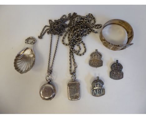Silver and white metal collectables: to include a white metal caddy spoon; three similar ARP lapel badges; and a fob type sov