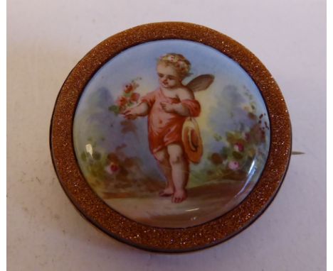 A Spanish ceramic set brooch, featuring a cherubic figure&nbsp; cased