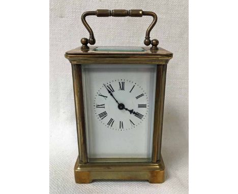 An early 20th century brass cased Carriage Clock of typical key wound form, white enamel face, unsigned with Roman numerals, 