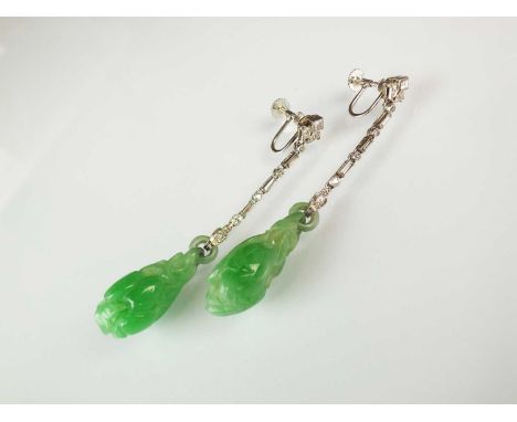 A pair of jade and diamond ear pendants, each designed as a carved jade pear shaped drop suspended from alternating brilliant