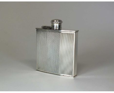 An Art Deco silver hip flask, James Carr, Birmingham 1939, of engine turned slightly faceted form with screw and hinge cap, 1