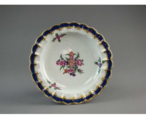 A Caughley polychrome dessert platecirca 1785-90of lobed form, nicely painted with a central spray of pink, purple and red fl