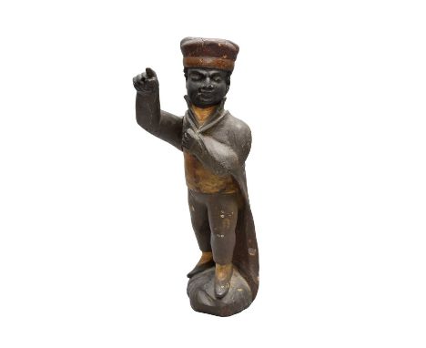 An early 19th century painted, carved treen, advertising figure, probably for tobacco, of a man standing with his left foot f