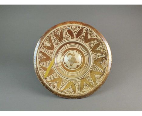 A Spanish Hispano-Moresque (Moorish) pottery charger18th/19th centurydecorated in copper lustre with a wide border of stylise