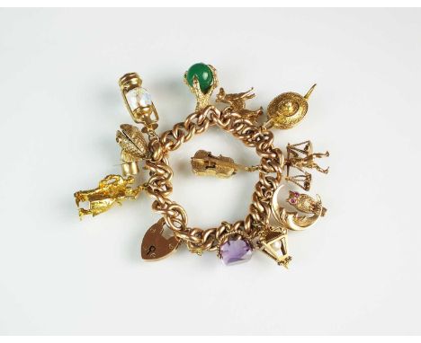 A rose metal hollow curb link bracelet with attached charms, the 9ct gold and yellow metal charms include; a top hat, a dog, 
