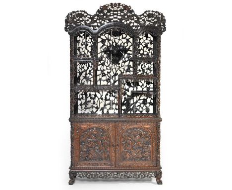 A fine Chinese carved hongmu rosewood cabinet, Qing Dynasty, 19th centuryThe triple-arched pierced cresting finely carved wit