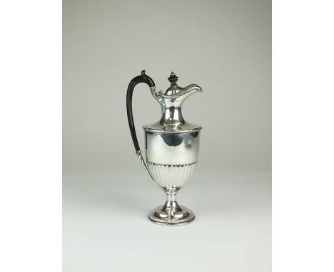 An Edwardian silver hot water jug, Elkington &amp; Co, Birmingham1907, of half reeded pedestal form with ebonised handle and 
