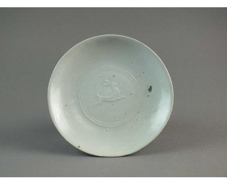 Bernard Leach (1887-1979)A St. Ives studio pottery dish with pale celadon glaze, circa 1965, decorated in low relief with a l