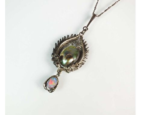 An Arts and Crafts abalone shell and opal pendant by Joseph Anton Hodel, Bromsgrove Guild, designed as a central oval abalone