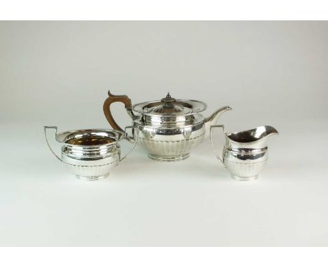 A George V three piece silver tea service, Elkington &amp; Co, Birmingham 1914, each piece of circular half reeded form, comp