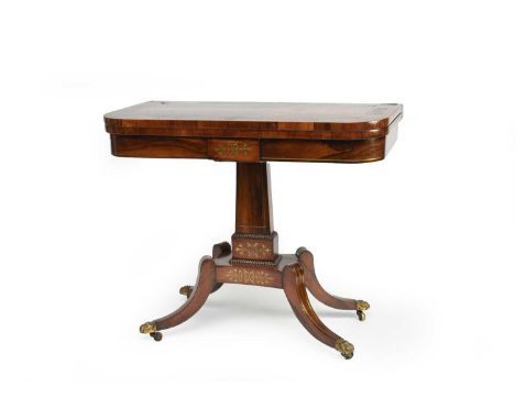 A late Regency rosewood and brass marquetry card table, inlaid with brass stringing, the rectangular, swivel, fold-over top a