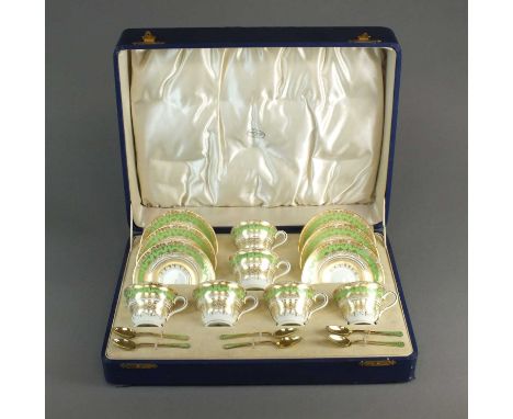 A Coalport tea servicedecorated with elaborate gilt details and green borders, pattern 9176, with six silver gilt and green e