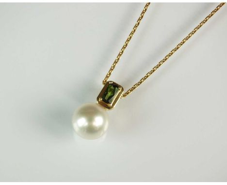 A cultured pearl and green tourmaline pendant, the rectangular faceted green tourmaline claw set in yellow metal suspending s
