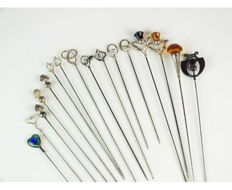 A collection of silver, white metal and yellow metal hat pins, comprising; a heart shaped silver and enamel example by Charle
