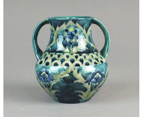 A William Moorcroft 'Late Florian' vasecirca 1915of twin-handled form, tubelined with flowers and leaves against a green grou