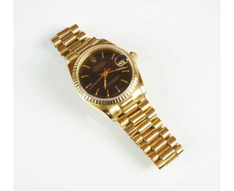 An 18ct gold mid-size Rolex Oyster Perpetual Datejust Superlative Chronometer wristwatch, the black dial with gold batons, da