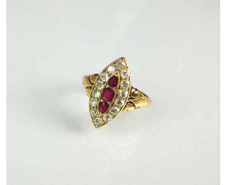 A late 19th century ruby and diamond marquise shaped ring, the three graduated faceted rubies claw set within a border of old