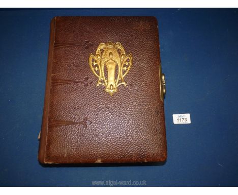 A Victorian photograph album, having interior floral decoration, original tissue papers, embossed leather covers and Art Nouv