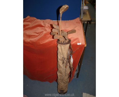 A vintage Golf bag of canvas and leather containing 16 antique Hickory golf Clubs including No. 51 hand forged special pitche