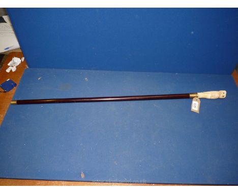 An ebonised vintage walking stick surmounted with a well carved bone owl knop and brass fittings. Approximately 90 cm long.