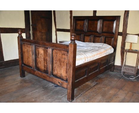 A heavy dark Oak double Bed having peg joined headboard with bevelled panels, 65 1/2" wide x 66 1/4" high and with four bevel