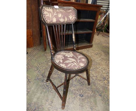 A heavy Arts and Crafts side Chair having a circular seat, turned legs and backrest supports, the back also with four stick s