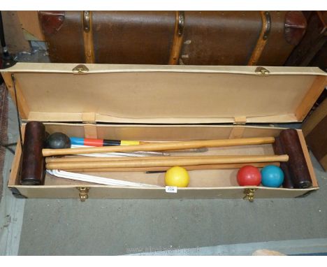A boxed vintage Croquet set with four mallets, balls and metals hoops, etc. 42'' x 10''