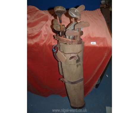 A large vintage canvas and leather Golf bag containing 17 antique Hickory golf Clubs including The Scot Spade Mashie.