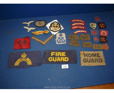 An assortment of fabric army patches including The Home Guard, Fire Guard, Middlesex Regiment, etc.