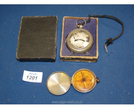 A pocket Voltmeter, boxed and a pocket Compass, made in Germany.
