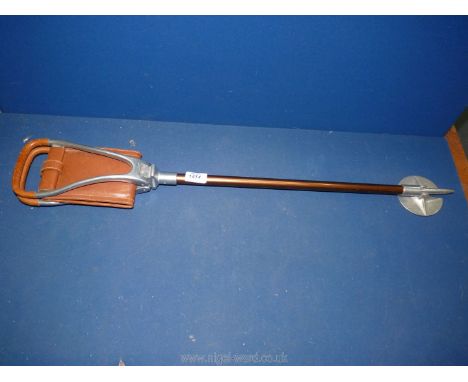 A brown leather seated shooting Stick.