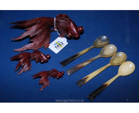 A set of three graduated models of Angel fish with ceramic eyes plus four horn spoons.