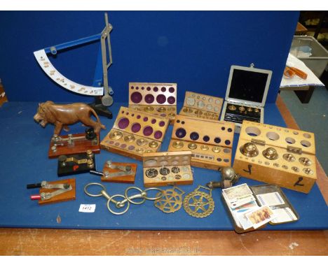 A quantity of incomplete boxed sets of weights, morse code tappers, horse brasses, tin of cigarette cards, Treen lion and sci